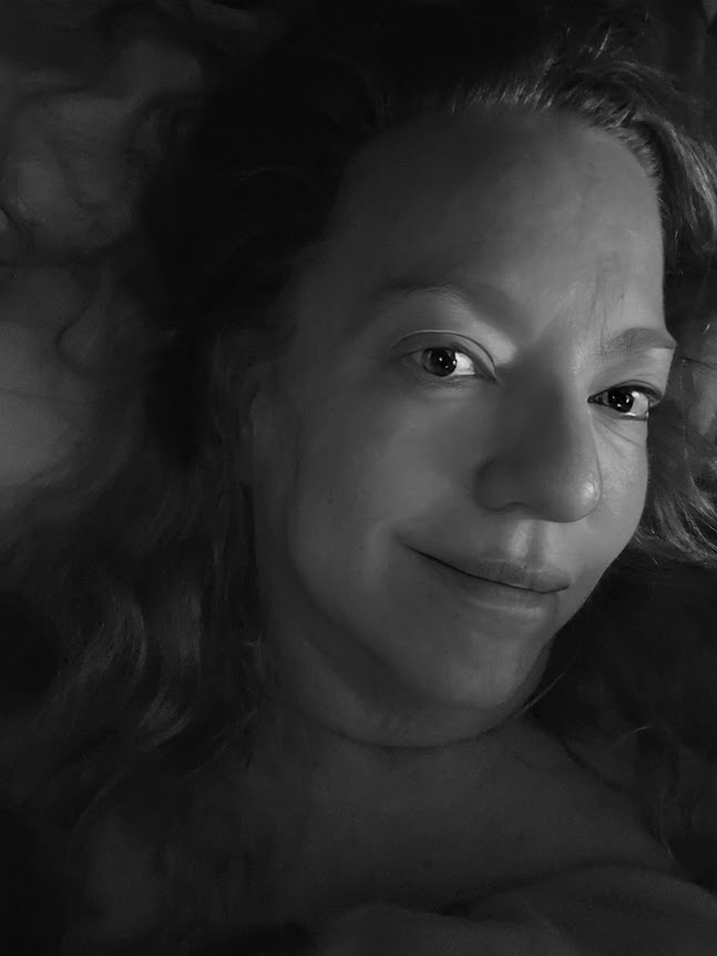 Close up black and white portrait of Joy, reflecting on her IBS journey with a calm and resilient expression .